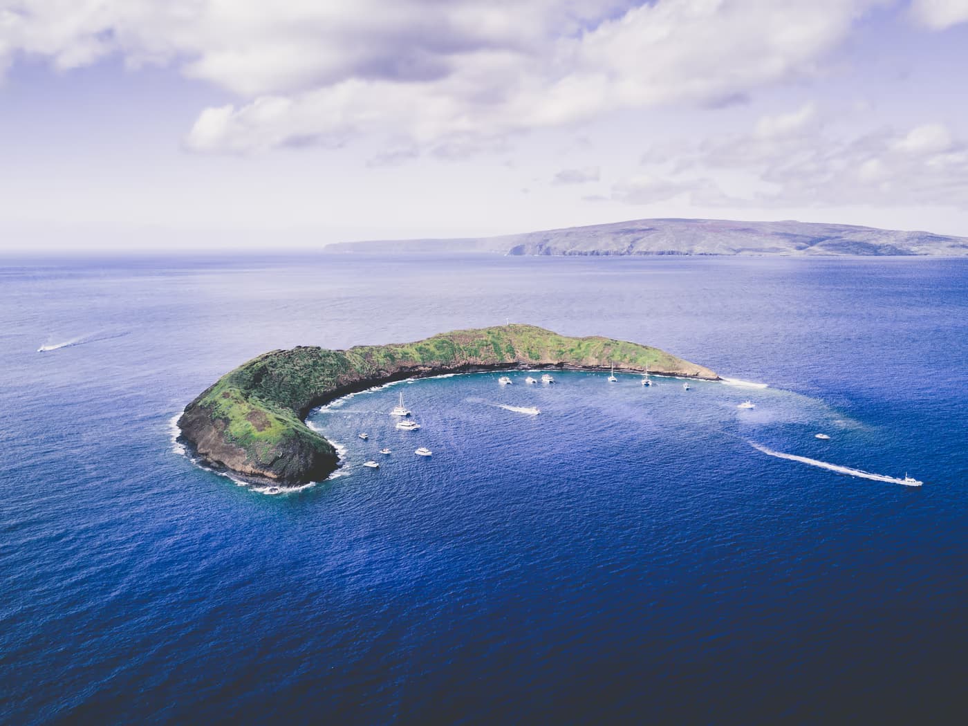 Snorkellers above the reef inside Molokini crater, off the south coast of Maui
